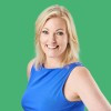 Blonde woman in a blue top with a green background