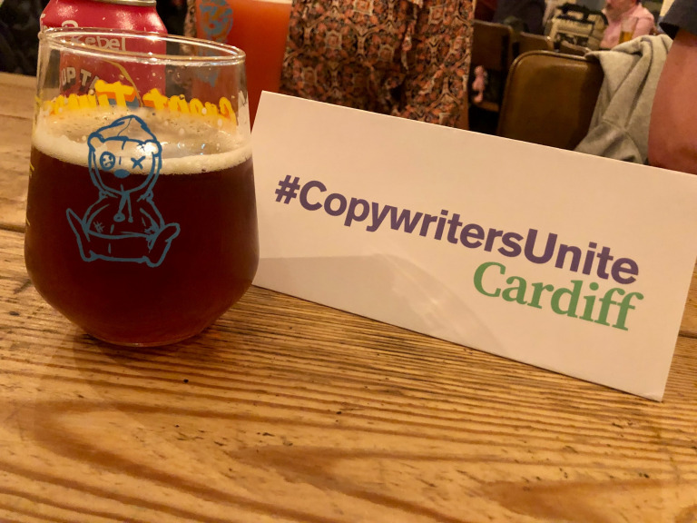 Picture of an indoor pot plant in a woven basket next to a miniature white and orange VW camper van